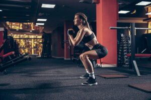 Comment faire un squat : une femme réalise un squat